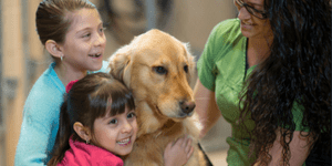 people hugging dog