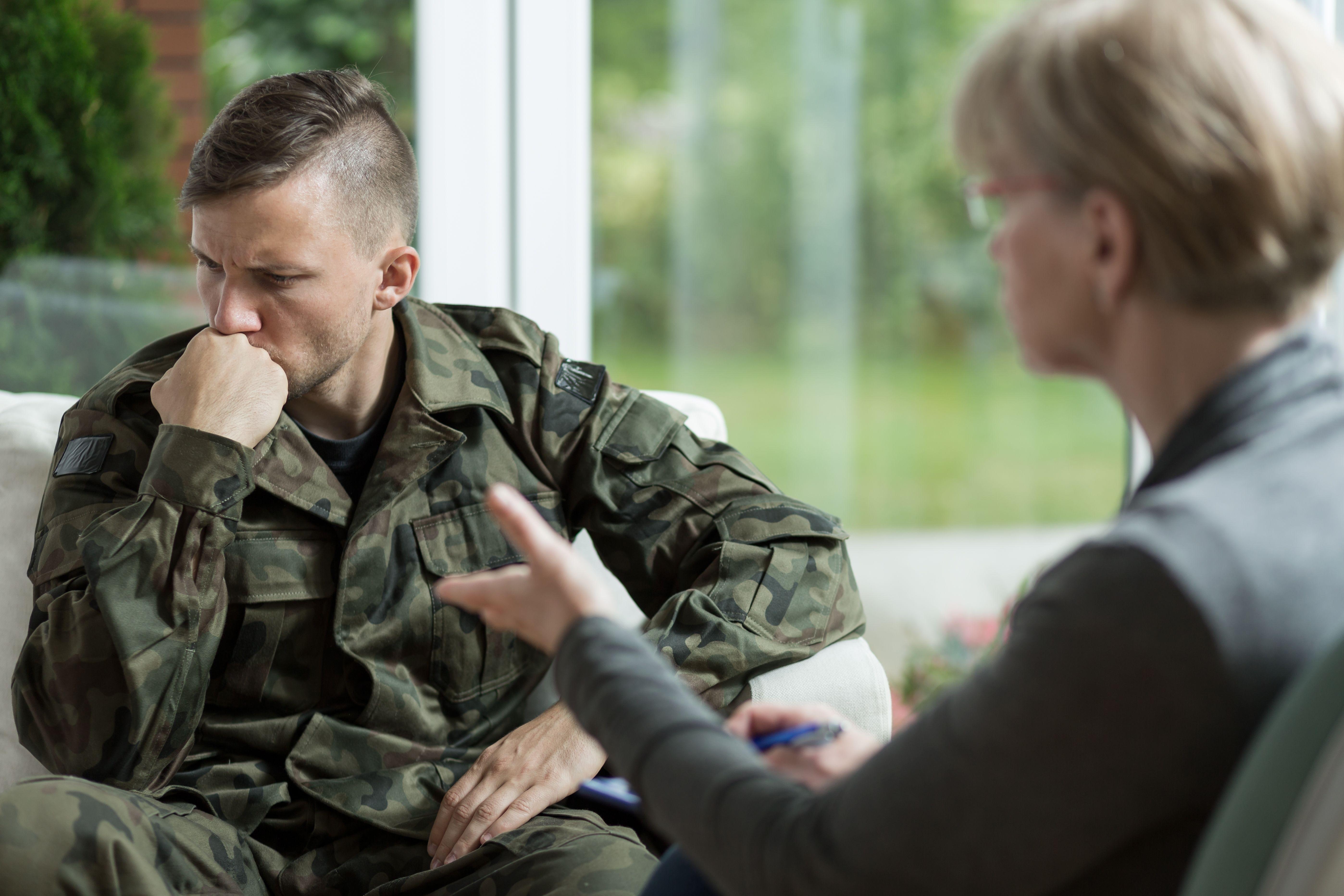 Soldier undergoing military intake interview with female recruiter